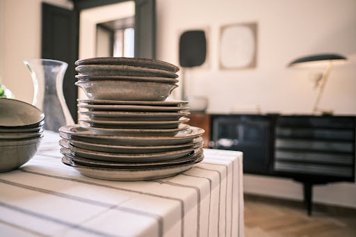 stacks of plates and bowls on a kitchen table