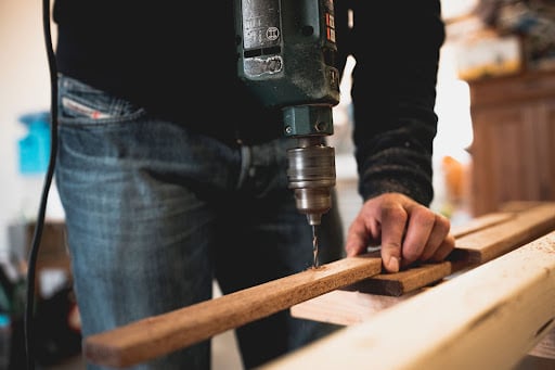 man building a wood bench